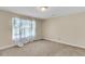 Simple bedroom featuring beige walls, carpet flooring, and a window with curtains at 834 Prince John Dr, Charleston, SC 29407