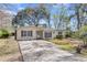 Well-kept single-story home with an expansive driveway and traditional architecture at 834 Prince John Dr, Charleston, SC 29407