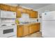 Functional kitchen with wood cabinets, white appliances and tile flooring at 834 Prince John Dr, Charleston, SC 29407
