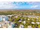Stunning aerial shot showcasing lush landscaping, marsh views, and well-maintained tennis courts in a desirable area at 94 Seaside Cottage Ln, Isle of Palms, SC 29451