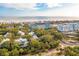 A stunning aerial view of a coastal community featuring tree-lined streets, and ocean views at 94 Seaside Cottage Ln, Isle of Palms, SC 29451