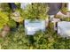 Birds eye view of a well-maintained home surrounded by verdant trees and manicured landscaping in a gated community at 94 Seaside Cottage Ln, Isle of Palms, SC 29451