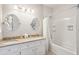 Well-appointed bathroom with double sinks, a soaking tub, and elegant fixtures at 94 Seaside Cottage Ln, Isle of Palms, SC 29451