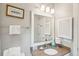 Well-lit bathroom featuring granite countertops, a framed mirror, and convenient towel storage at 94 Seaside Cottage Ln, Isle of Palms, SC 29451