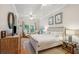 Bright and airy bedroom with a large bed, ceiling fan, and views of the outdoor scenery at 94 Seaside Cottage Ln, Isle of Palms, SC 29451