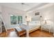 Bedroom with white walls, hardwood floors, and large windows letting in plenty of natural light at 94 Seaside Cottage Ln, Isle of Palms, SC 29451