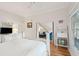 Well-lit bedroom featuring hardwood floors and a view to the living room and staircase at 94 Seaside Cottage Ln, Isle of Palms, SC 29451