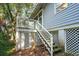 Charming home exterior featuring a quaint porch with stairs, lattice work, and lush landscaping at 94 Seaside Cottage Ln, Isle of Palms, SC 29451