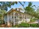 Charming home featuring a wide porch, cottage details, and a well-manicured front yard in a desirable neighborhood at 94 Seaside Cottage Ln, Isle of Palms, SC 29451