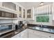 Cozy kitchen with stainless steel appliances, granite countertops, and ample natural light at 94 Seaside Cottage Ln, Isle of Palms, SC 29451