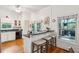 Charming kitchen with white cabinets, breakfast bar, and views to the outdoor deck at 94 Seaside Cottage Ln, Isle of Palms, SC 29451