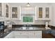 Bright kitchen features stainless steel appliances, granite counters, and a view of the backyard at 94 Seaside Cottage Ln, Isle of Palms, SC 29451