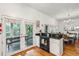 Well-designed kitchen with an oven and access to a charming outdoor dining space at 94 Seaside Cottage Ln, Isle of Palms, SC 29451