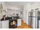 Open kitchen with a refrigerator and stove flowing seamlessly into the dining area at 94 Seaside Cottage Ln, Isle of Palms, SC 29451