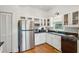 Well-lit kitchen featuring stainless steel refrigerator, white cabinets and stainless steel appliances at 94 Seaside Cottage Ln, Isle of Palms, SC 29451