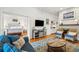 Cozy living room with hardwood floors, fireplace, and comfortable seating with an adjacent bedroom at 94 Seaside Cottage Ln, Isle of Palms, SC 29451