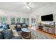 Bright living room offering comfortable denim seating and an adjacent view to a covered porch at 94 Seaside Cottage Ln, Isle of Palms, SC 29451
