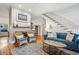 Inviting living room featuring hardwood floors, a fireplace, and comfortable denim seating at 94 Seaside Cottage Ln, Isle of Palms, SC 29451