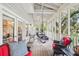 Screened porch featuring comfortable seating and views of the surrounding trees at 94 Seaside Cottage Ln, Isle of Palms, SC 29451