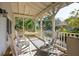 Inviting front porch featuring rocking chairs and a hammock, perfect for relaxing outdoors at 94 Seaside Cottage Ln, Isle of Palms, SC 29451