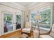 Sitting room with a chair and a view of the screened porch with a hammock and outdoor furniture at 94 Seaside Cottage Ln, Isle of Palms, SC 29451