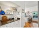 Stylish wet bar area featuring granite countertops, white cabinets, and convenient bar seating at 94 Seaside Cottage Ln, Isle of Palms, SC 29451