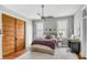 Cozy bedroom with a ceiling fan, decorative pillows, and a sliding closet door at 318 Sumter St, Charleston, SC 29403