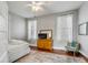 Bright bedroom with hardwood floors, a dresser, and two windows with white curtains at 318 Sumter St, Charleston, SC 29403