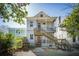 Two-story home with wood siding, an exterior staircase, and a small upper and lower porch at 318 Sumter St, Charleston, SC 29403
