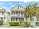 Charming two-story home with double porches, well-manicured landscaping and a beautiful palm tree at 318 Sumter St, Charleston, SC 29403