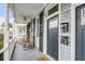 A view of front porch with rocking chairs, ceiling fan, and door with charming decor at 318 Sumter St, Charleston, SC 29403