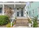 Inviting front porch with steps leading to the entrances of homes 318 and 320 at 318 Sumter St, Charleston, SC 29403