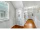 Long hallway with wood floors, white trim, and a view of the front entrance at 318 Sumter St, Charleston, SC 29403