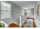 Well-lit hallway with a window, hardwood floors, and a staircase leading to the second floor at 318 Sumter St, Charleston, SC 29403
