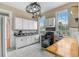 Bright kitchen featuring white cabinets, modern appliances, and natural light from large windows at 318 Sumter St, Charleston, SC 29403