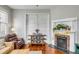 Cozy living room with a decorative fireplace, stylish furnishings and hardwood floors at 318 Sumter St, Charleston, SC 29403