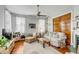 Comfortable living room features a ceiling fan, vintage decor, and hardwood floors at 318 Sumter St, Charleston, SC 29403