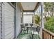 Quaint porch with an outdoor table and four chairs on a colorful rug, perfect for relaxation at 318 Sumter St, Charleston, SC 29403