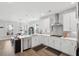 Open-concept kitchen with stainless steel appliances, white cabinets and an island with counter seating at 100 Pine Waters Ln, Summerville, SC 29483