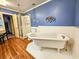 Modern bathroom featuring a claw foot tub, updated fixtures and laminate flooring at 1003 Wichman St, Walterboro, SC 29488