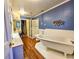 Modern bathroom featuring a claw foot tub, updated fixtures and laminate flooring at 1003 Wichman St, Walterboro, SC 29488