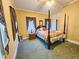 Cozy bedroom with vintage style curtains, a four-poster bed, and neutral wall colors at 1003 Wichman St, Walterboro, SC 29488