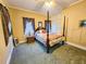 Bedroom featuring a four-poster bed, vintage curtains, and neutral wall colors at 1003 Wichman St, Walterboro, SC 29488