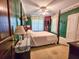 Green bedroom featuring a four poster bed with neutral walls and carpeting at 1003 Wichman St, Walterboro, SC 29488