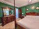 Bedroom features a four poster bed, green walls, and classic wood furnishings at 1003 Wichman St, Walterboro, SC 29488