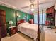 Bedroom with four poster bed, green walls, carpet and traditional furnishings at 1003 Wichman St, Walterboro, SC 29488