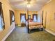 Bedroom with a four-poster bed, vintage curtains, and a ceiling fan at 1003 Wichman St, Walterboro, SC 29488