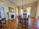 Dining room with hardwood floors, fireplace, chandelier and lots of natural light at 1003 Wichman St, Walterboro, SC 29488