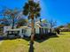 Classic two-story home with front yard palm and blue skies at 1003 Wichman St, Walterboro, SC 29488