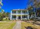 A beautiful two-story home with a large front porch, classic columns, and a well-manicured lawn at 1003 Wichman St, Walterboro, SC 29488